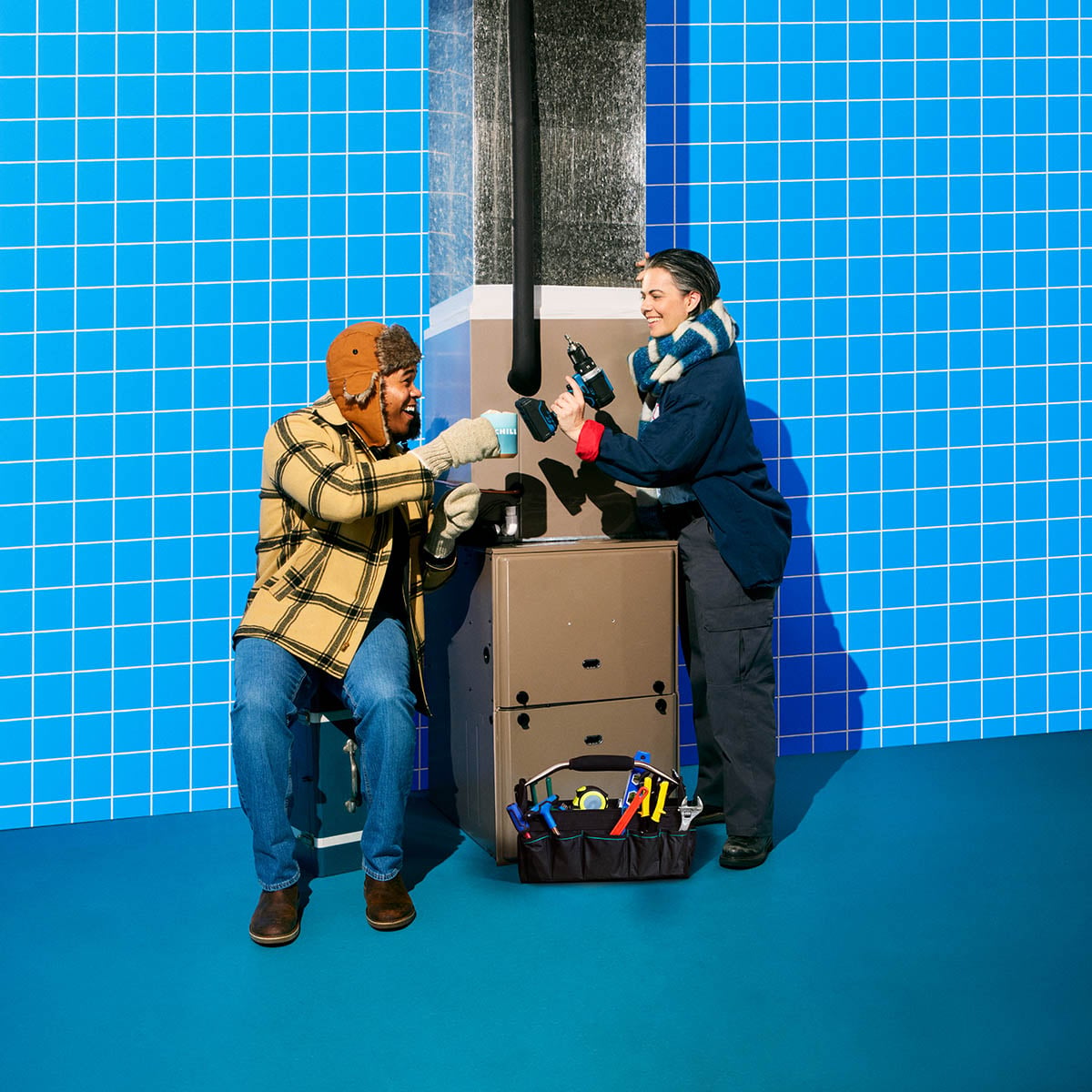 Technician and homeowner in front of heater furnace