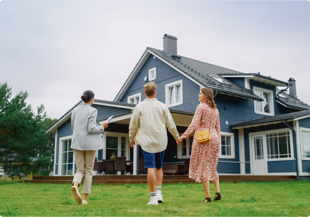 real estate agent outside home with couple