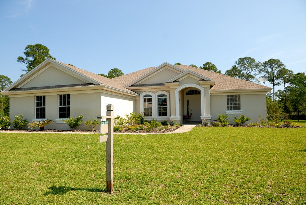 House with For Sale Sign in Front Yard