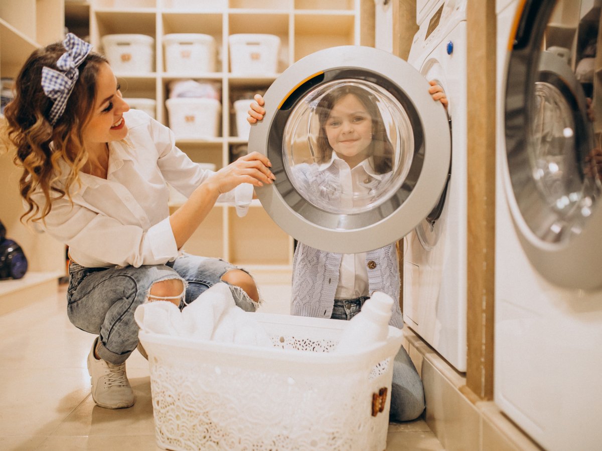 Child looking through dryer door window