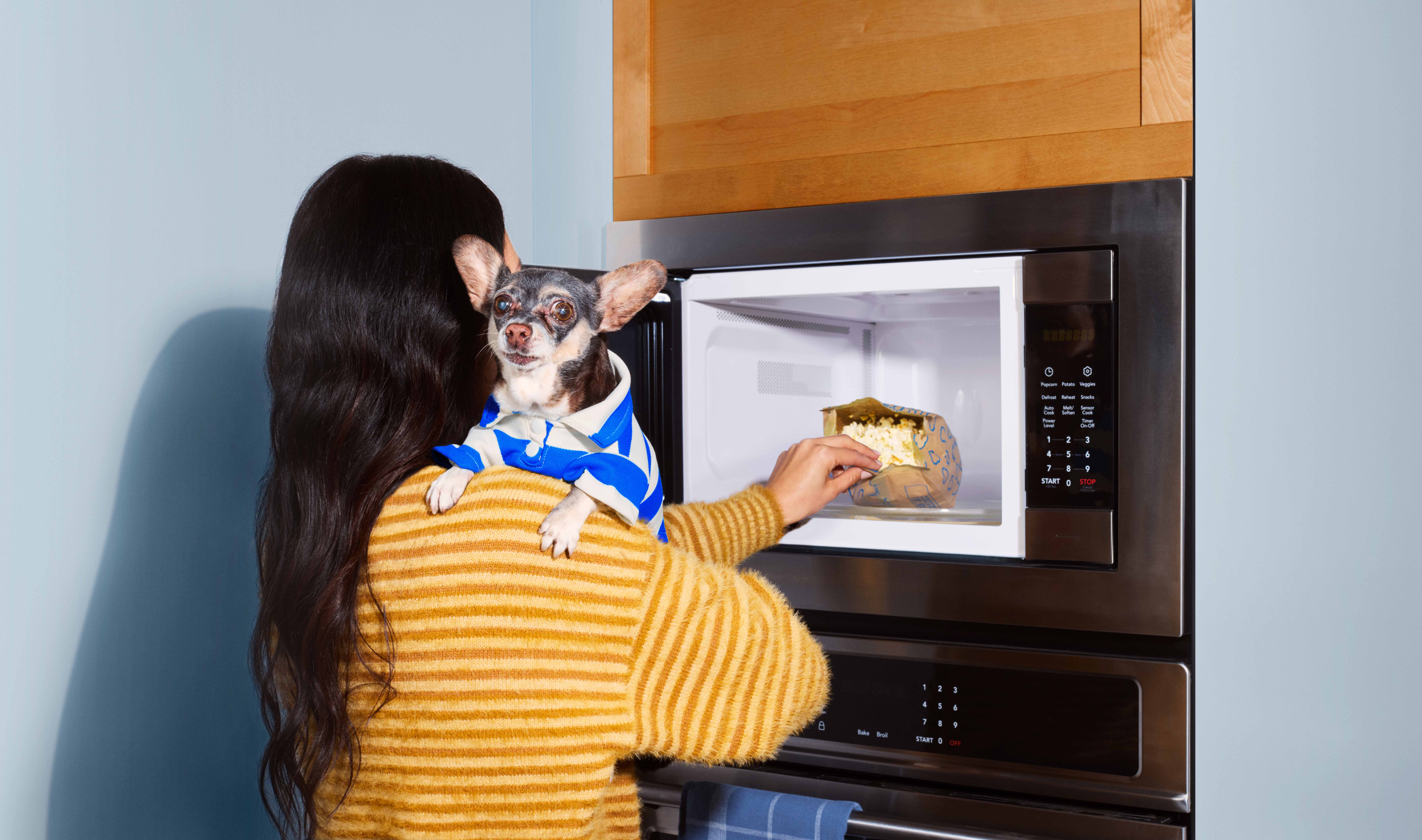 woman entering time on a built in microwave