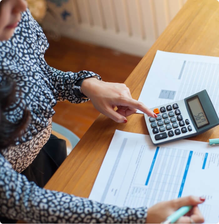 Woman using calculator.