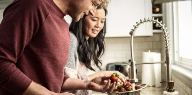 Couple washing dishes together