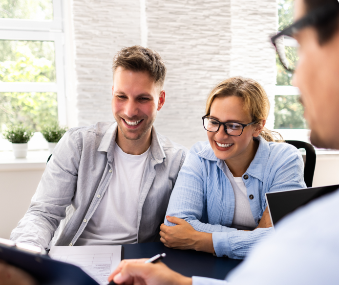 People sitting on couch looking at computer