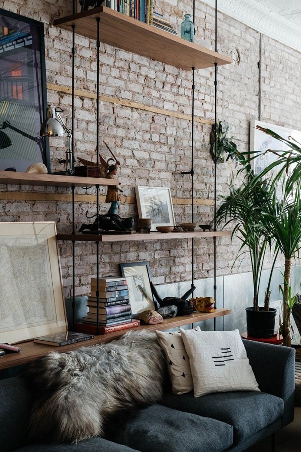 bookshelf on brick wall