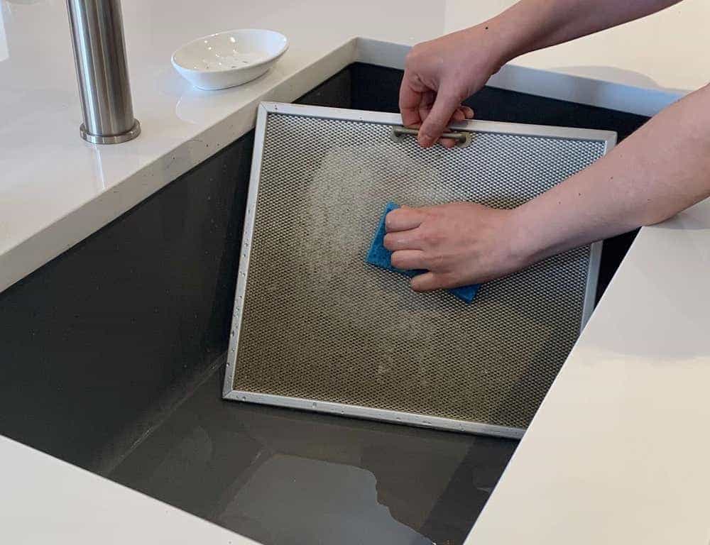 cleaning a vent hood in a sink