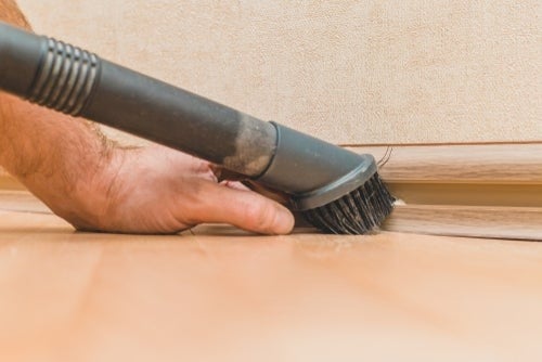 vacuuming baseboard