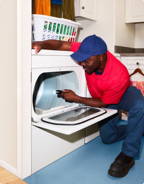 Plumber looking under sink